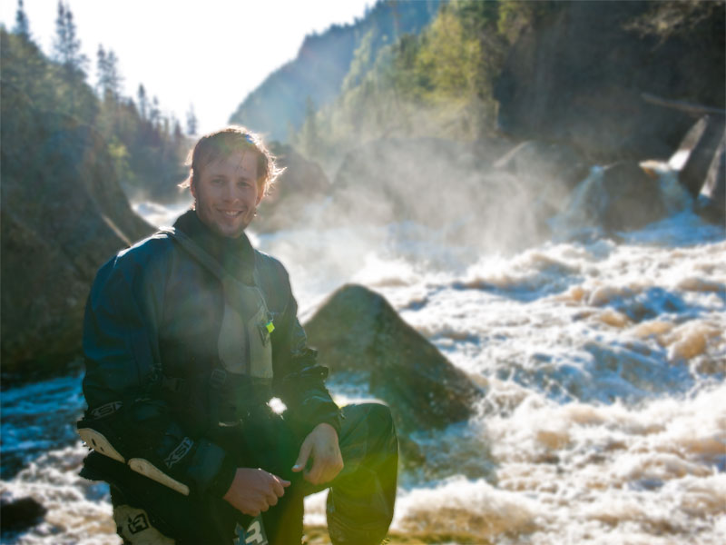 Chris Schwer posing in front of the second largest rapid on the Jaques-Cartier Northwest near Quebec City, Canada.